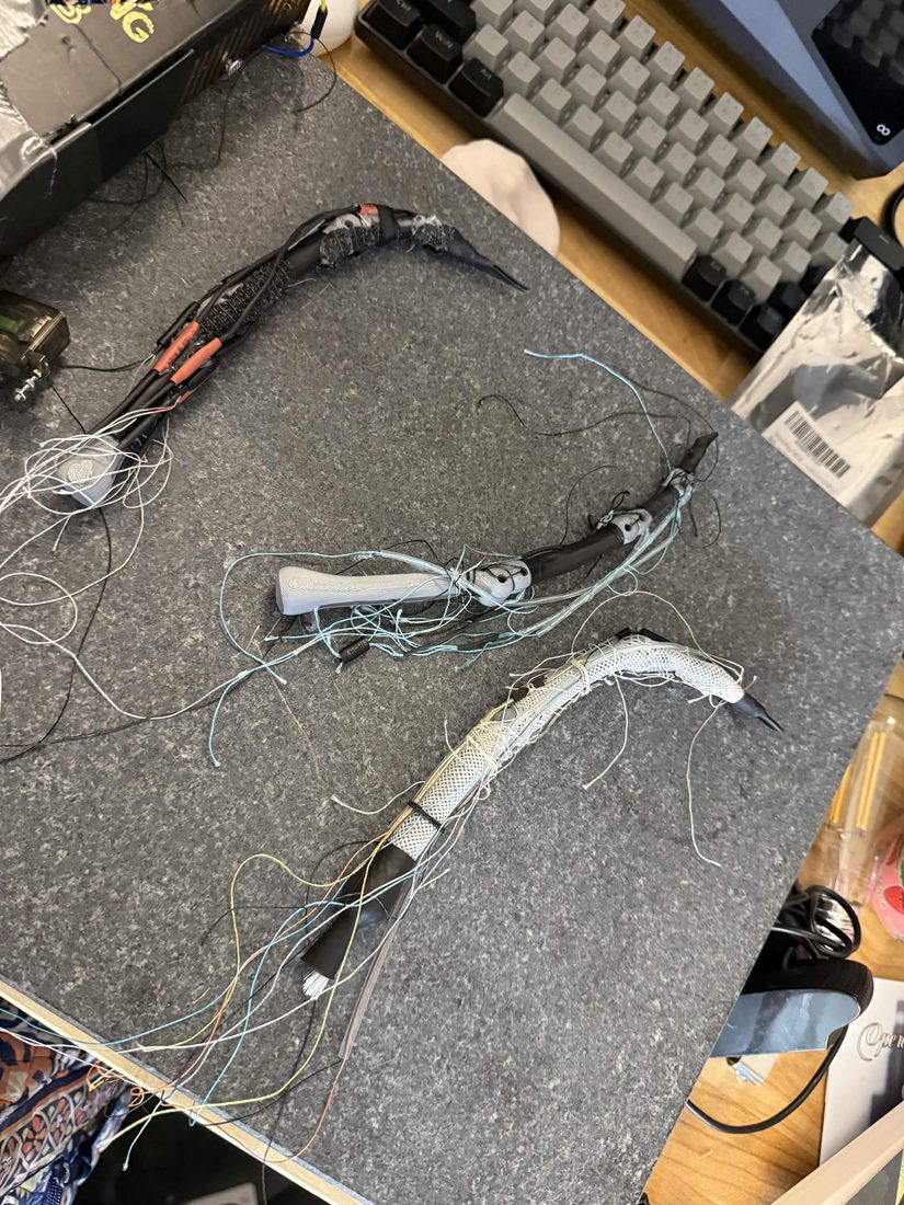 three finger prototypes: bone, wired, mesh-sheathed